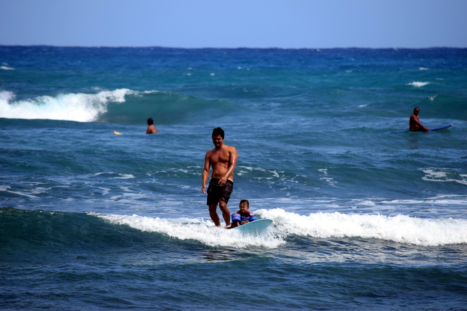 Der kleine Surfer scheint begeistert.