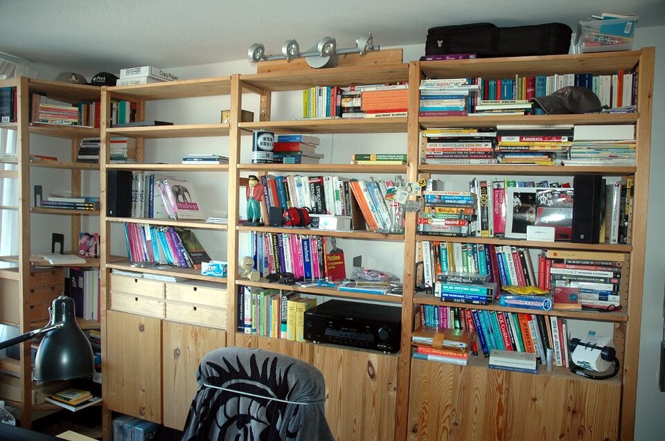 The book shelf in Michael's home office is getting cleared out.